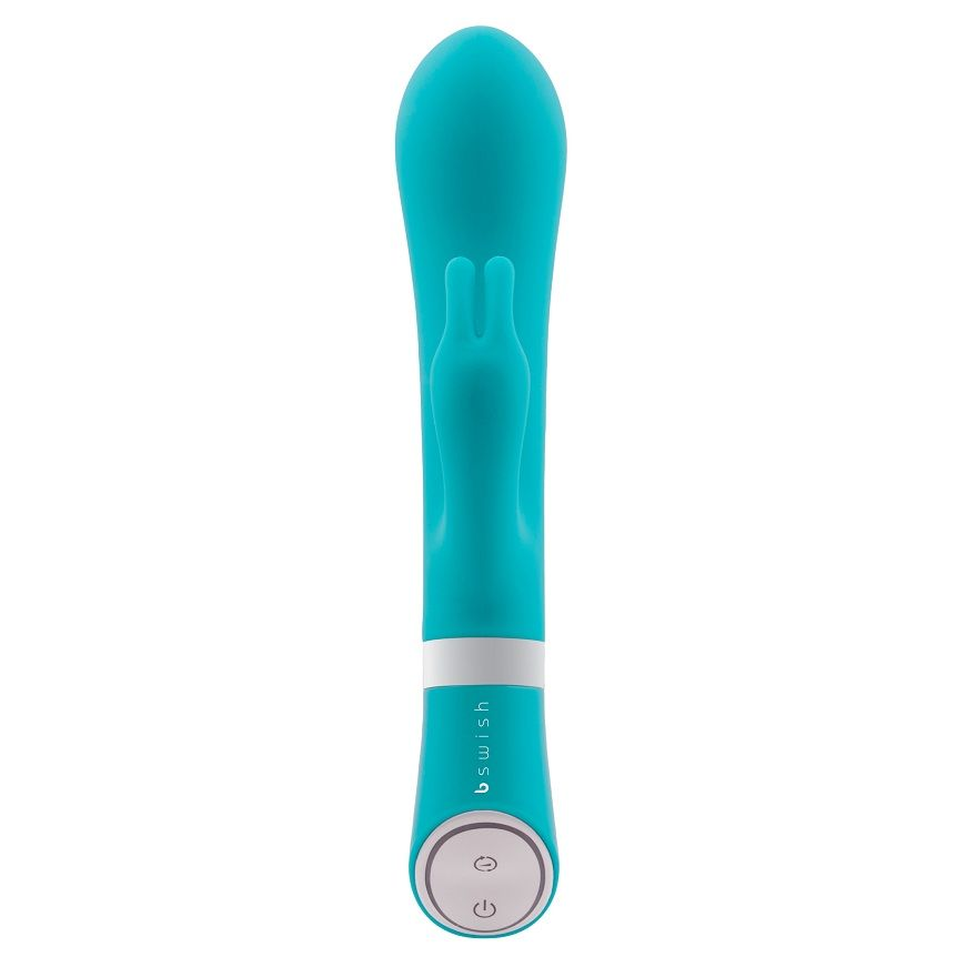 Un vibrador de varita turquesa con un anillo blanco y botones de control redondos sobre fondo blanco.
