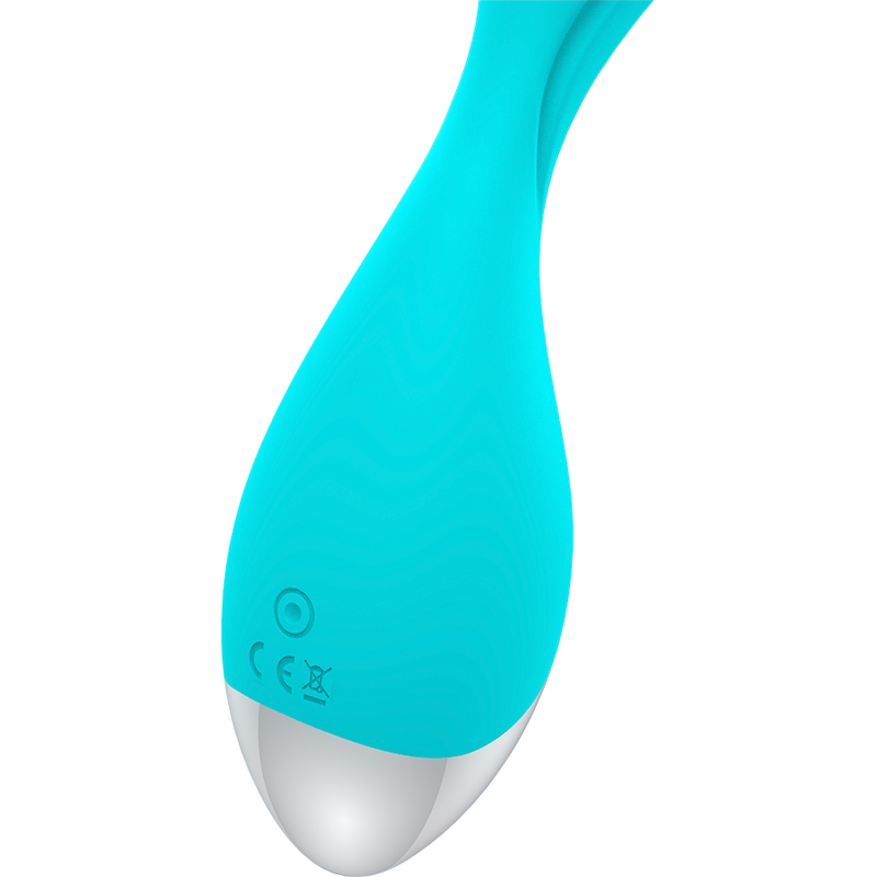 Ein türkisfarbenes, ergonomisches Gerät mit silbernem, rundem Boden und Knöpfen vor weißem Hintergrund.