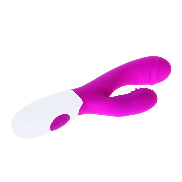 Un vibrador morado y blanco de doble estimulación con dos cabezales de masaje sobre fondo blanco.