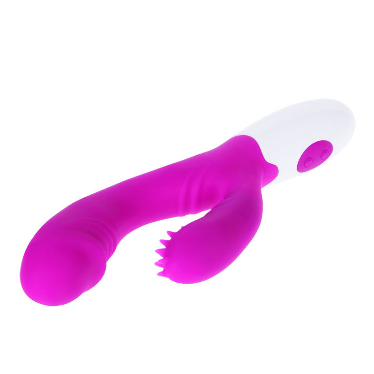 Un vibrador blanco y magenta con protuberancias en la parte inferior sobre fondo blanco.