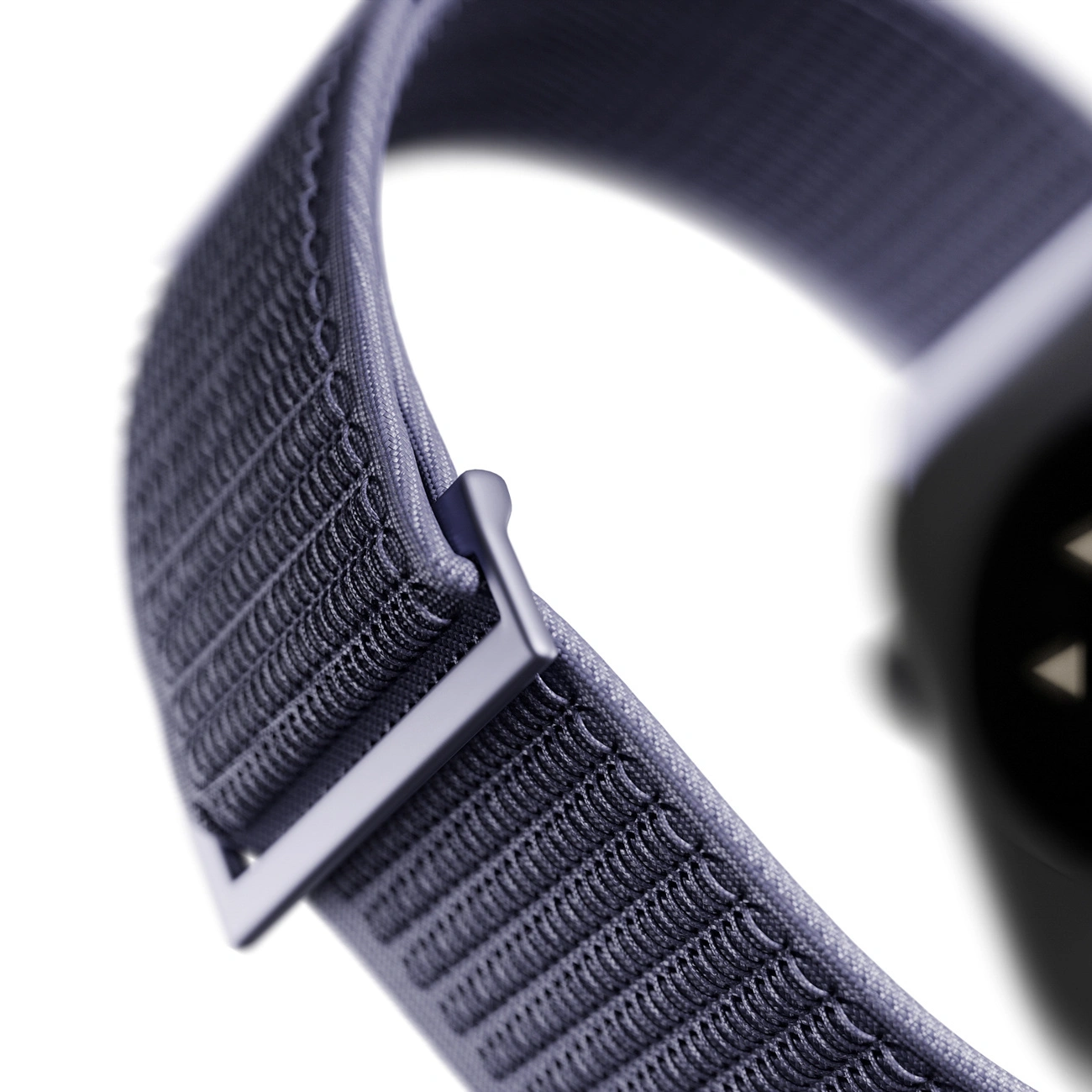 Primer plano de una correa de reloj inteligente de tela azul con hebilla metálica sobre fondo blanco.