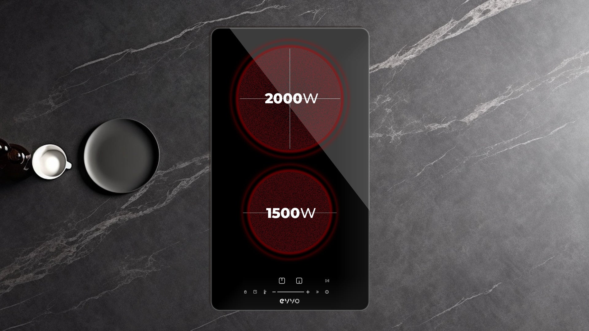 Una placa de inducción doble negra con 2000W y 1500W en una encimera de mármol oscuro.
