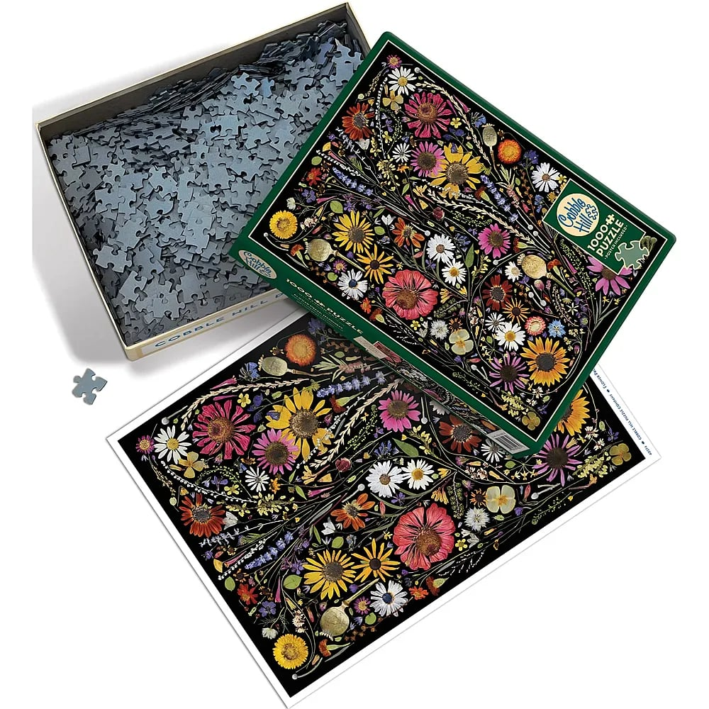 Ein 1000-Teile-Puzzle mit buntem Blumenarrangement auf schwarzem Hintergrund, Karton und Poster.