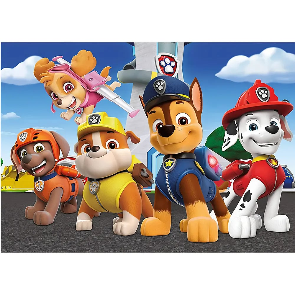 Five Paw Patrol puppies in uniform stand in front of their tower under a blue sky.