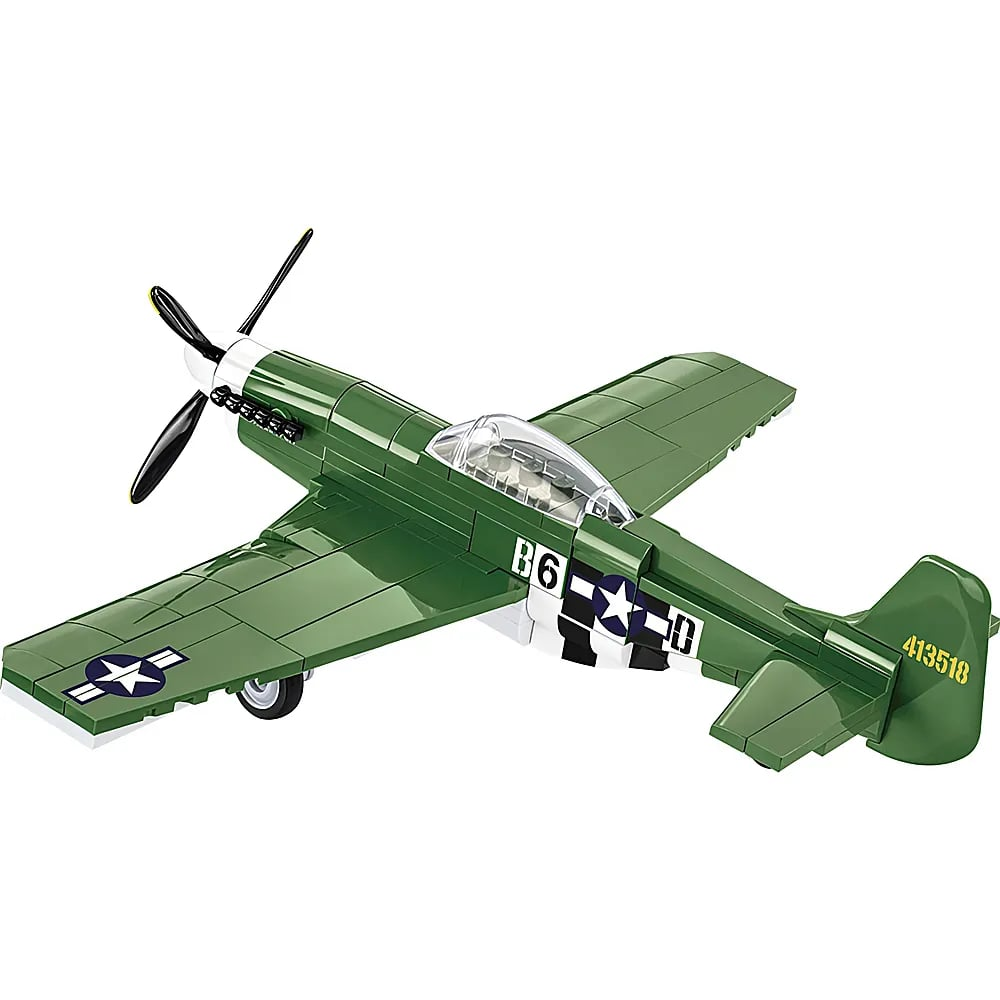 Un jouet d'avion vert en blocs de construction avec une étoile blanche et une hélice.