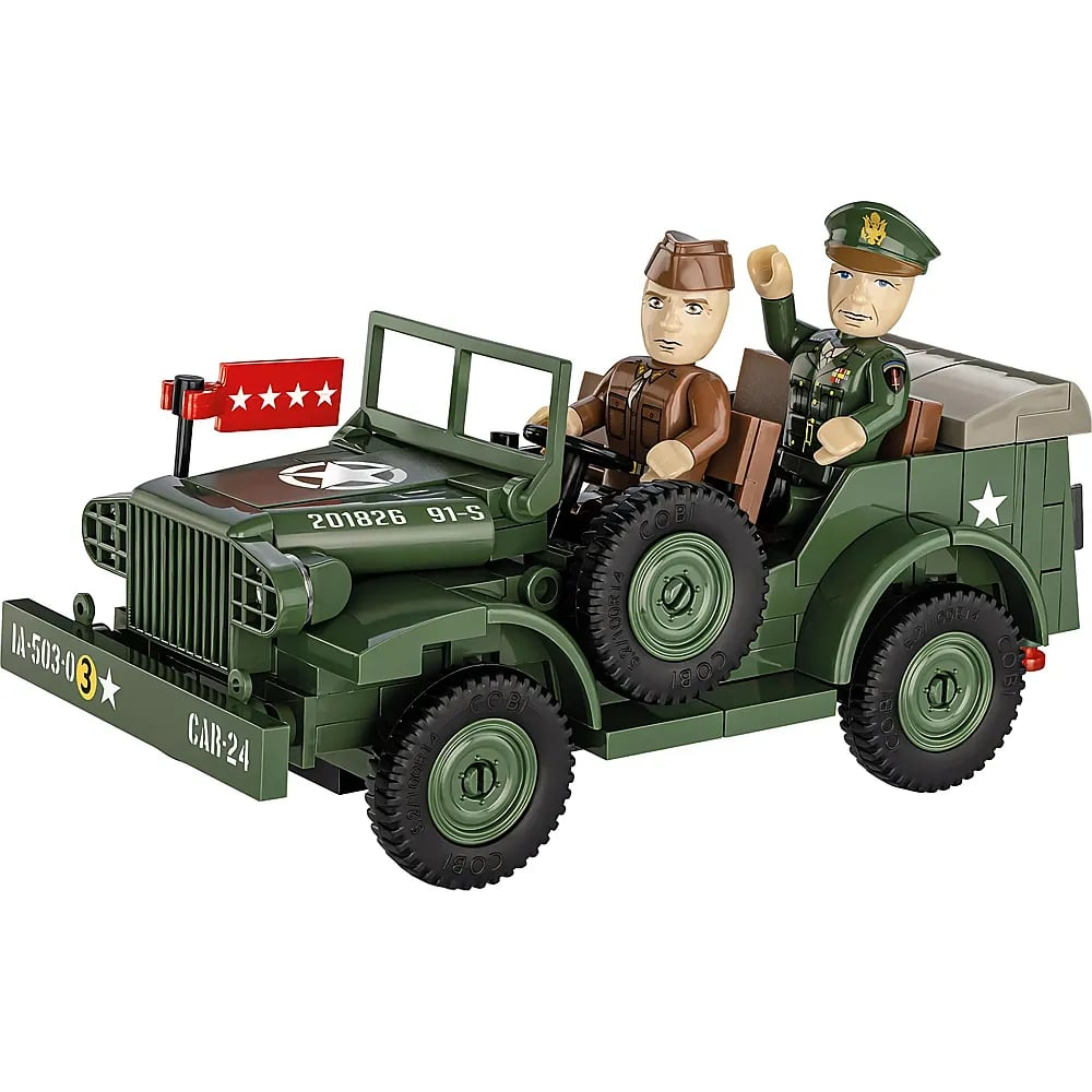 Véhicule militaire jouet vert avec deux figurines en uniforme, l'une faisant coucou.