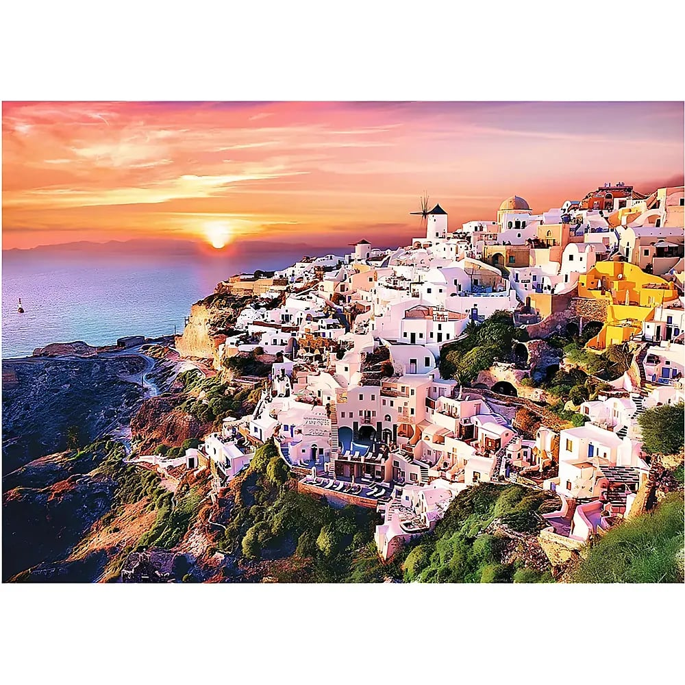 Santorini sunset view showing white cliffside buildings overlooking the blue sea under an orange sky.