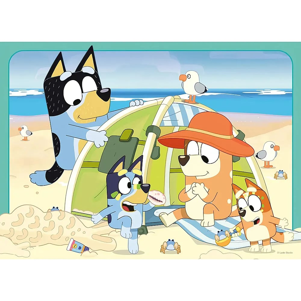 Perros azules y naranjas disfrutan de un día de playa cerca de una tienda con gaviotas y cangrejos.