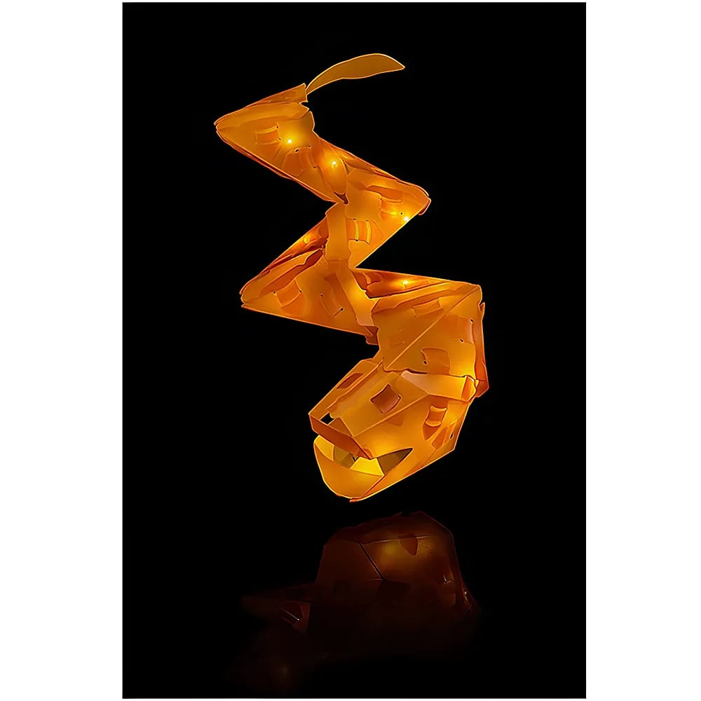Una scultura di serpente in origami arancione illuminata zigzaga verticalmente su sfondo nero, con riflesso sottostante.