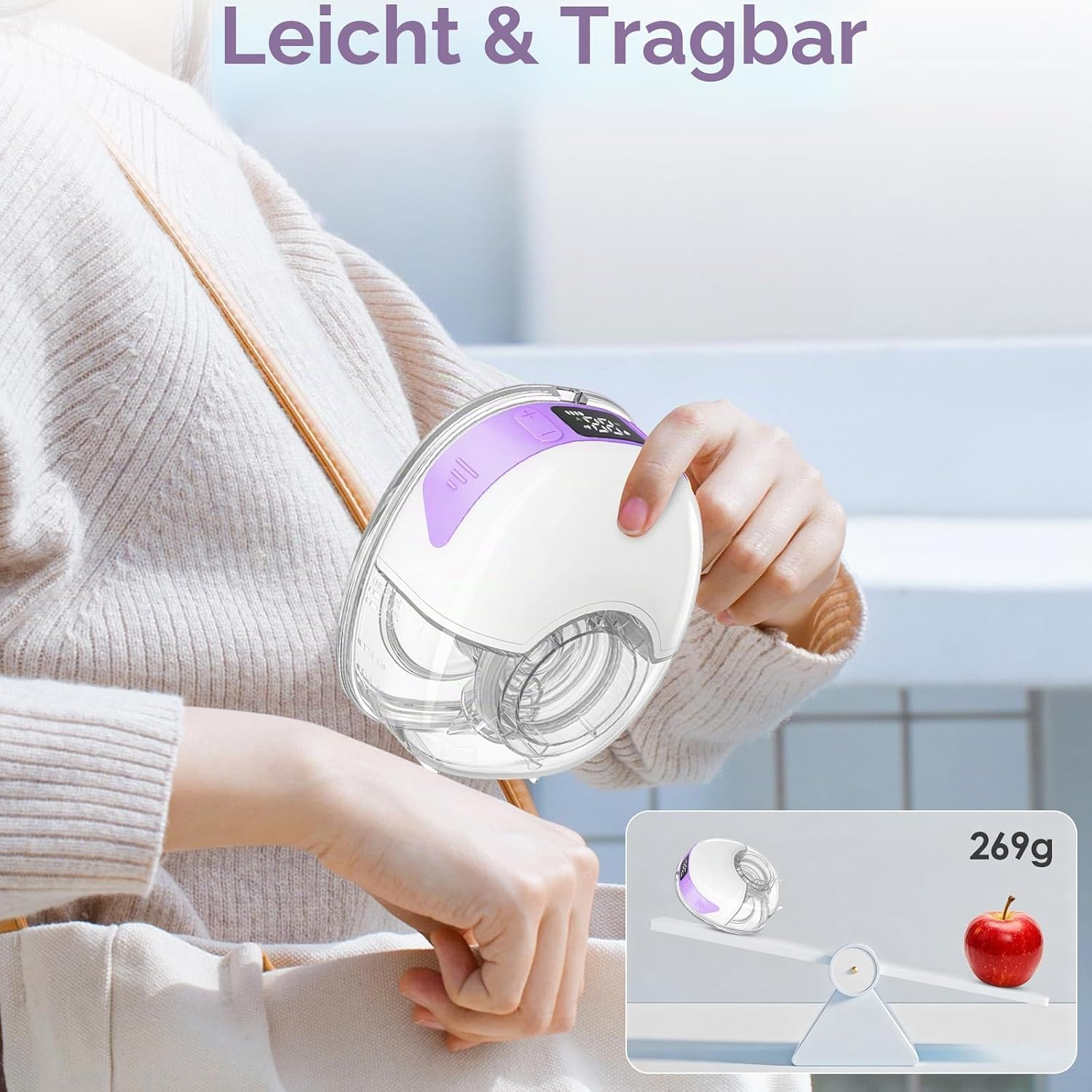 Eine Frau hält eine tragbare Milchpumpe, die wie auf einer Wippe mit einem Apfel 269g wiegt.
