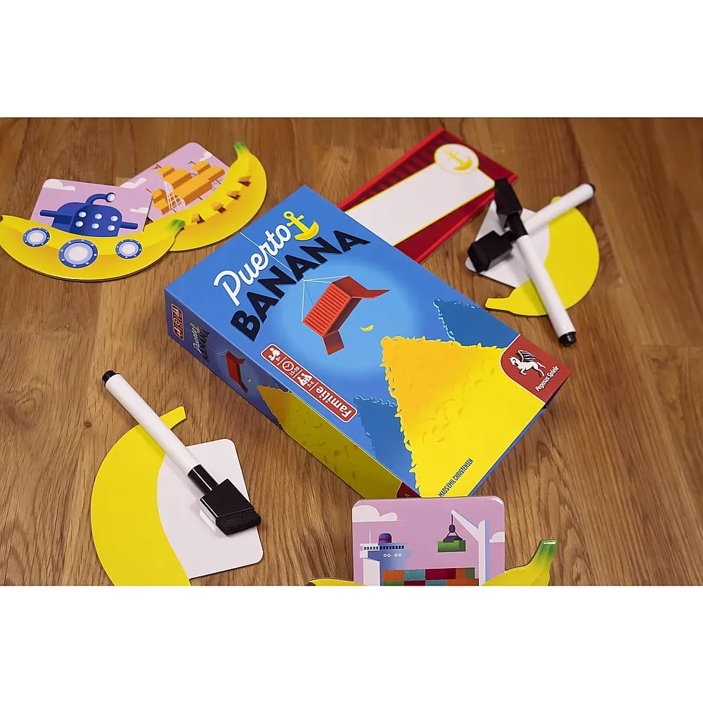 Das Brettspiel Puerto Banana liegt auf Holz mit bunten Karten, Markern und gelben Bananenformen.