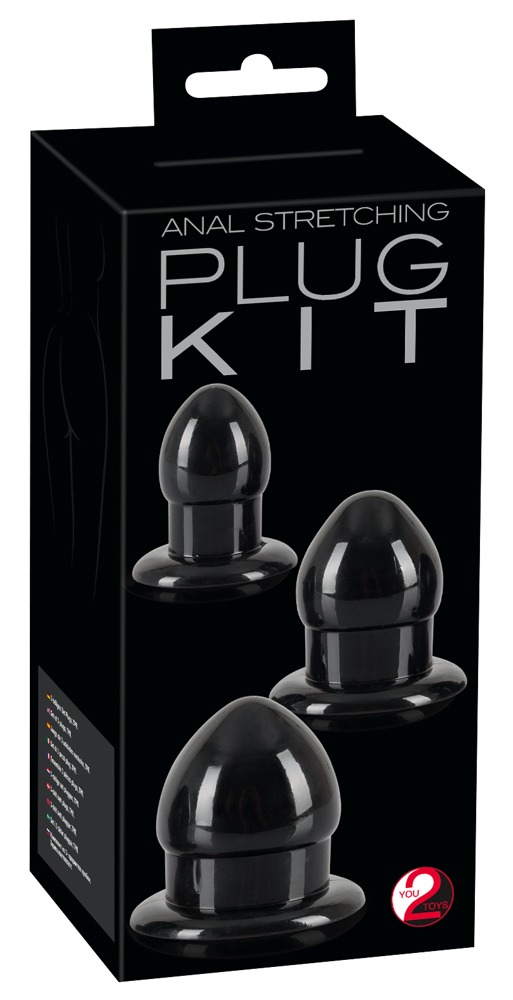 Eine schwarze Box mit der Aufschrift Anal Stretching Plug Kit zeigt drei glänzende schwarze Plug-Spielzeuge.