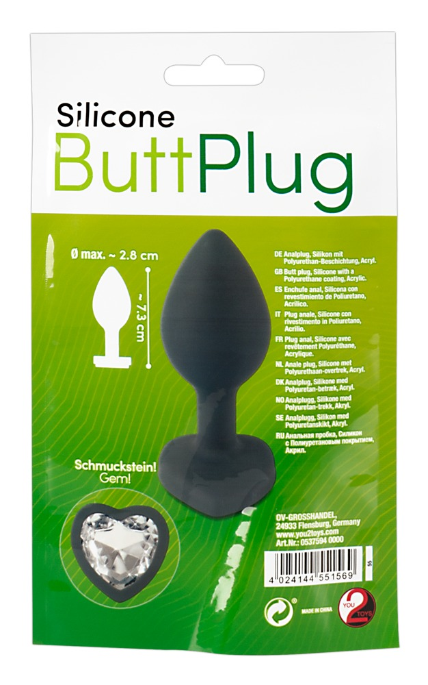 Verpackung eines schwarzen Silikon-Analplug mit einem herzförmigen Schmuckstein auf grünem Hintergrund.