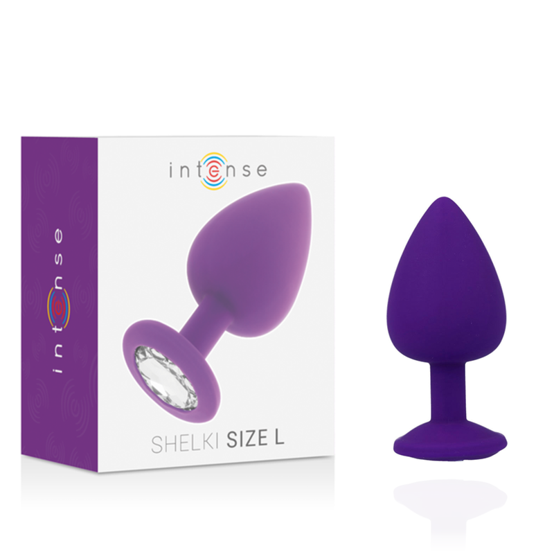 Ein lila Analplug mit Strassstein in der Basis steht neben seiner weiß-lila Produktverpackung.