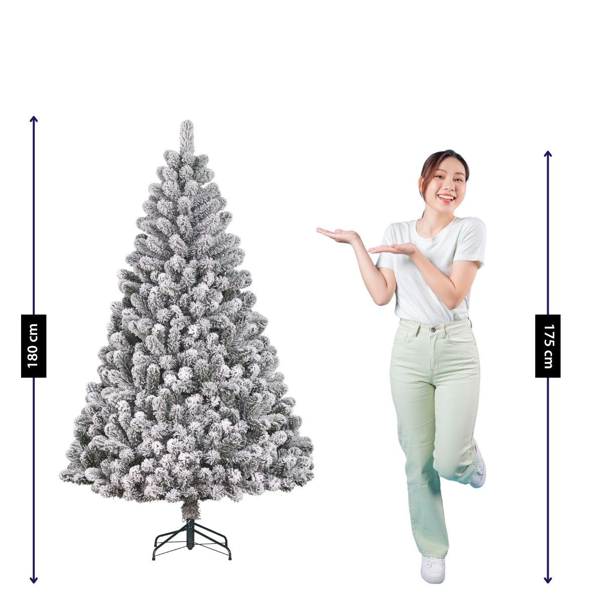 A woman in light clothing stands beside a 180 cm artificial snow-covered Christmas tree.