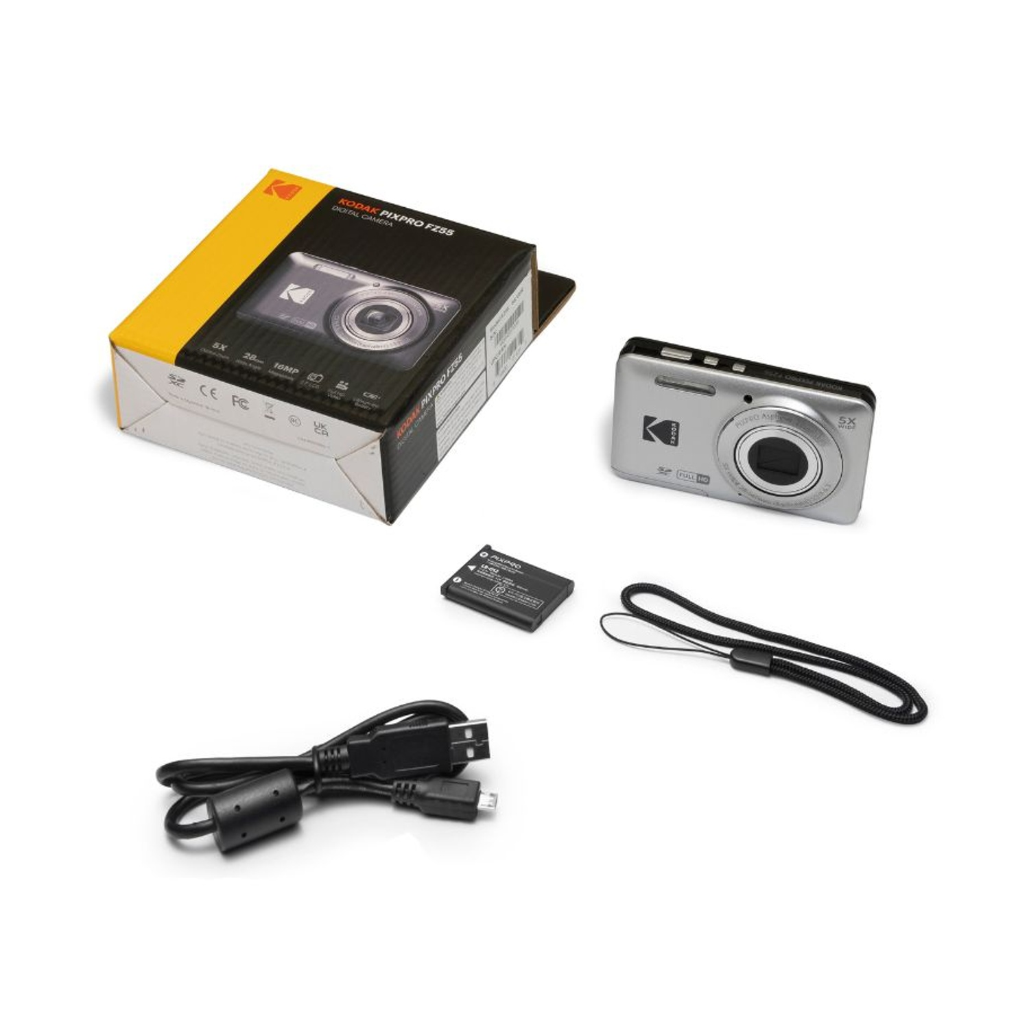 Eine silberne Kodak Digitalkamera mit schwarzer Box, Akku, Handschlaufe und USB-Kabel auf weißem Grund.