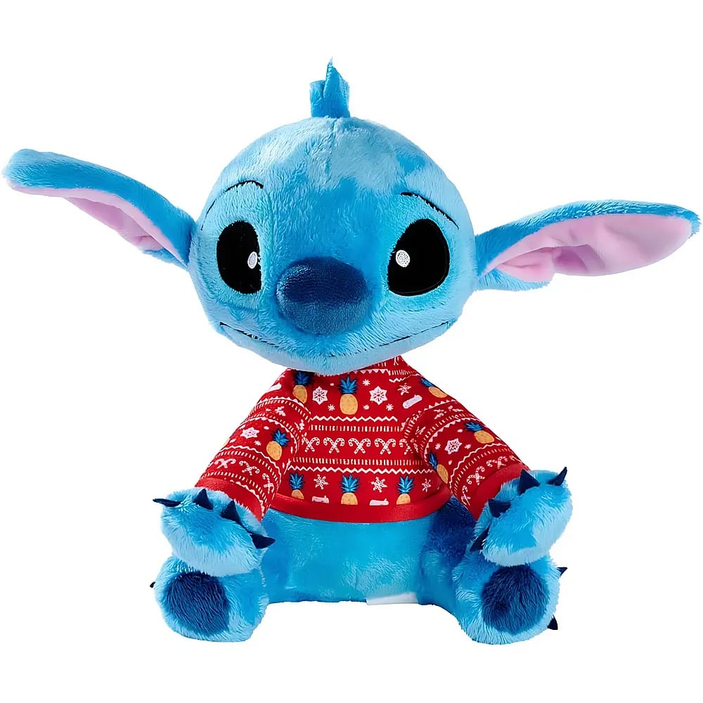 Blaue Plüschfigur Stitch im roten Weihnachtspullover mit Ananas- und Schneeflockenmuster vor weißem Hintergrund.