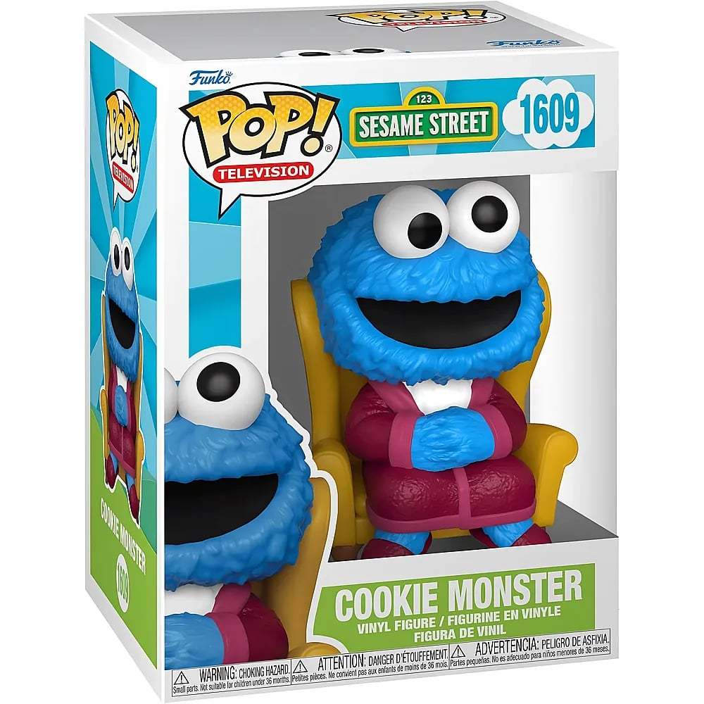 Una figura de vinilo Funko Pop de Cookie Monster en bata roja, sentado en un sillón amarillo dentro de su caja.
