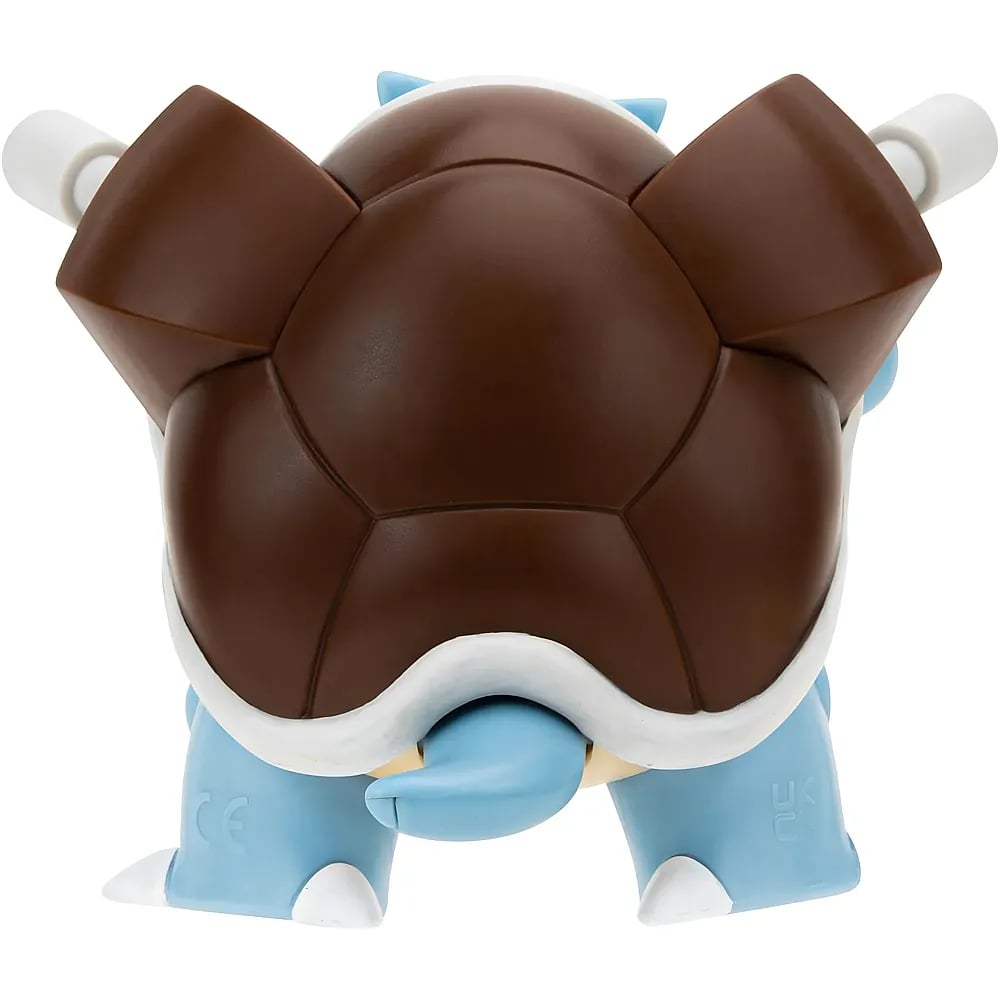 Vue arrière d'une figurine bleue de Tortank montrant sa grande carapace brune et deux canons.