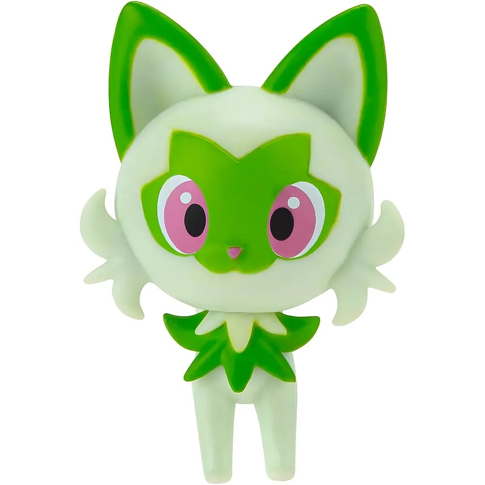 Eine weiße und grüne Katzenfigur mit großen pinken Augen und spitzen Ohren vor weißem Hintergrund.