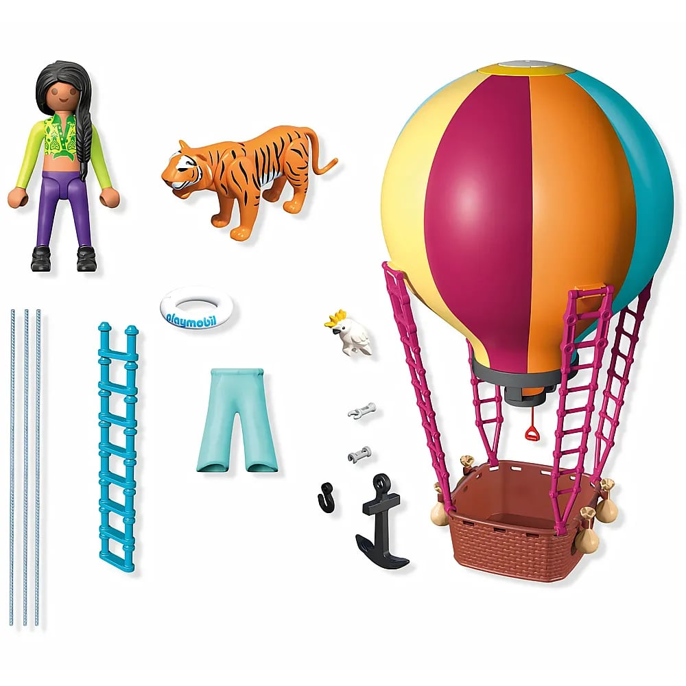 Set de Playmobil con globo aerostático colorido, figura, tigre, loro y accesorios sobre fondo blanco.