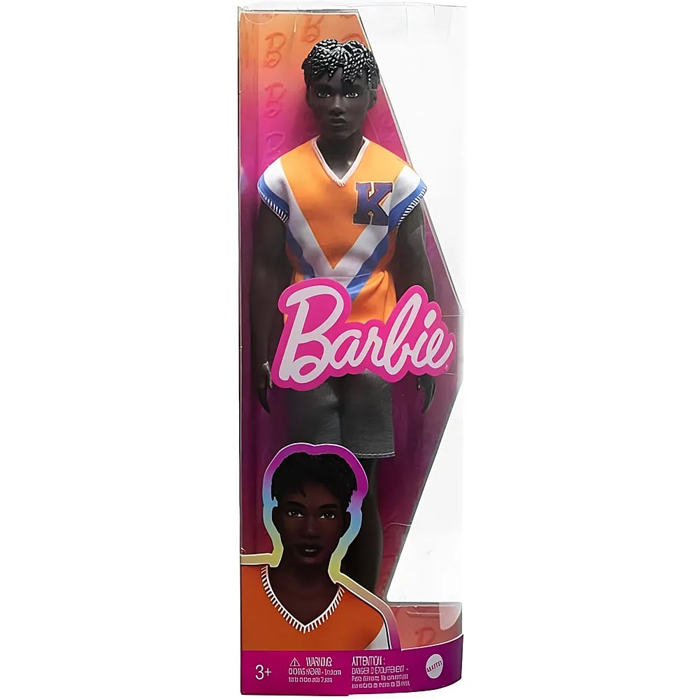 Eine Barbie-Puppe in einer Verpackung. Die männliche Puppe trägt ein orange-weißes Trikot mit einem großen Buchstaben K.