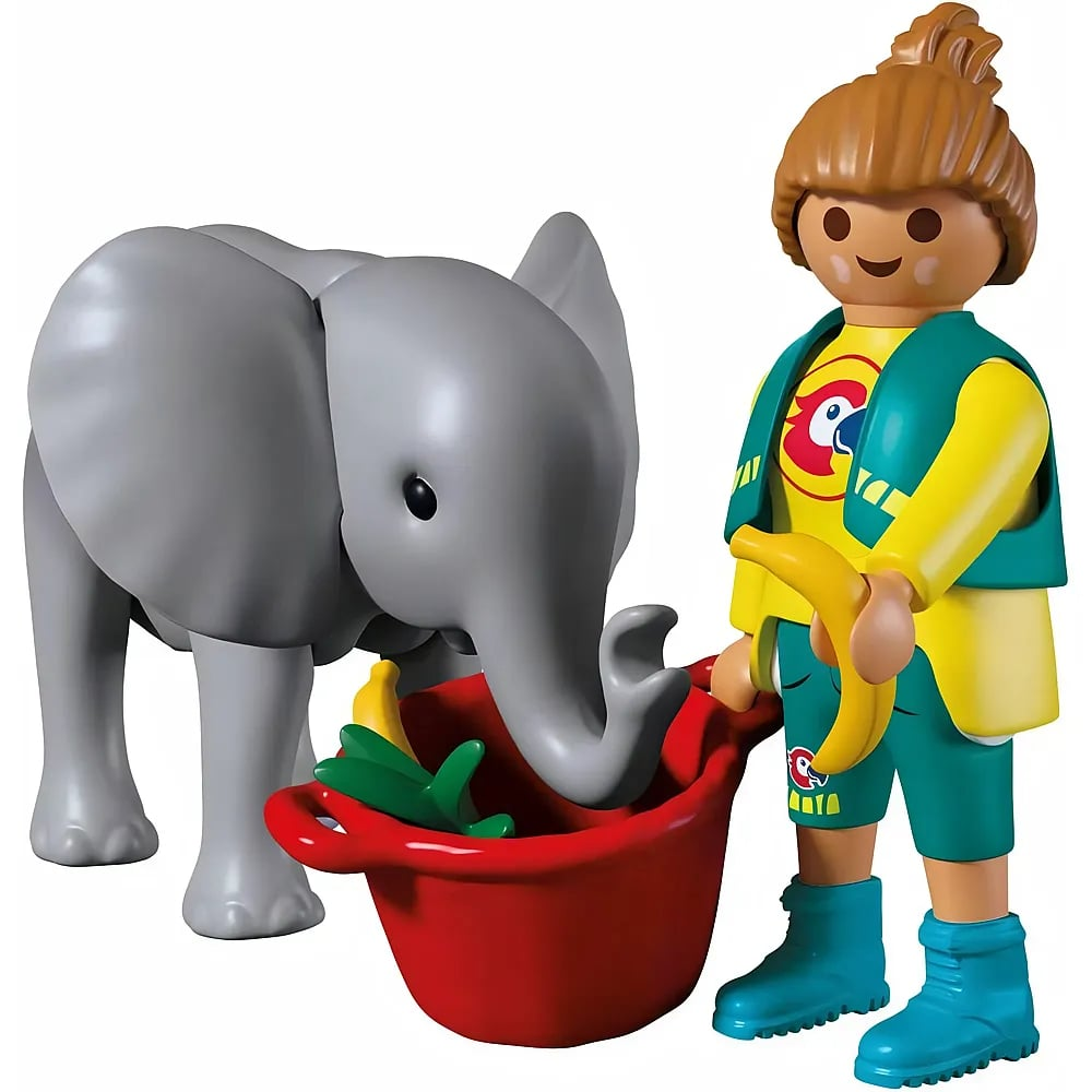 Figura de Playmobil alimentando a un elefante gris con fruta de un comedero rojo.