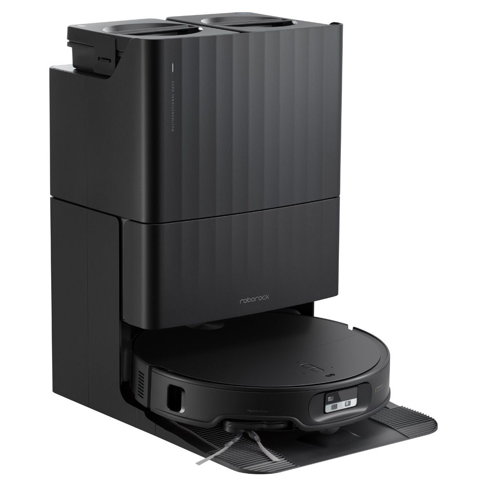 Un aspirateur robot Roborock noir ancré dans sa station multifonctionnelle.