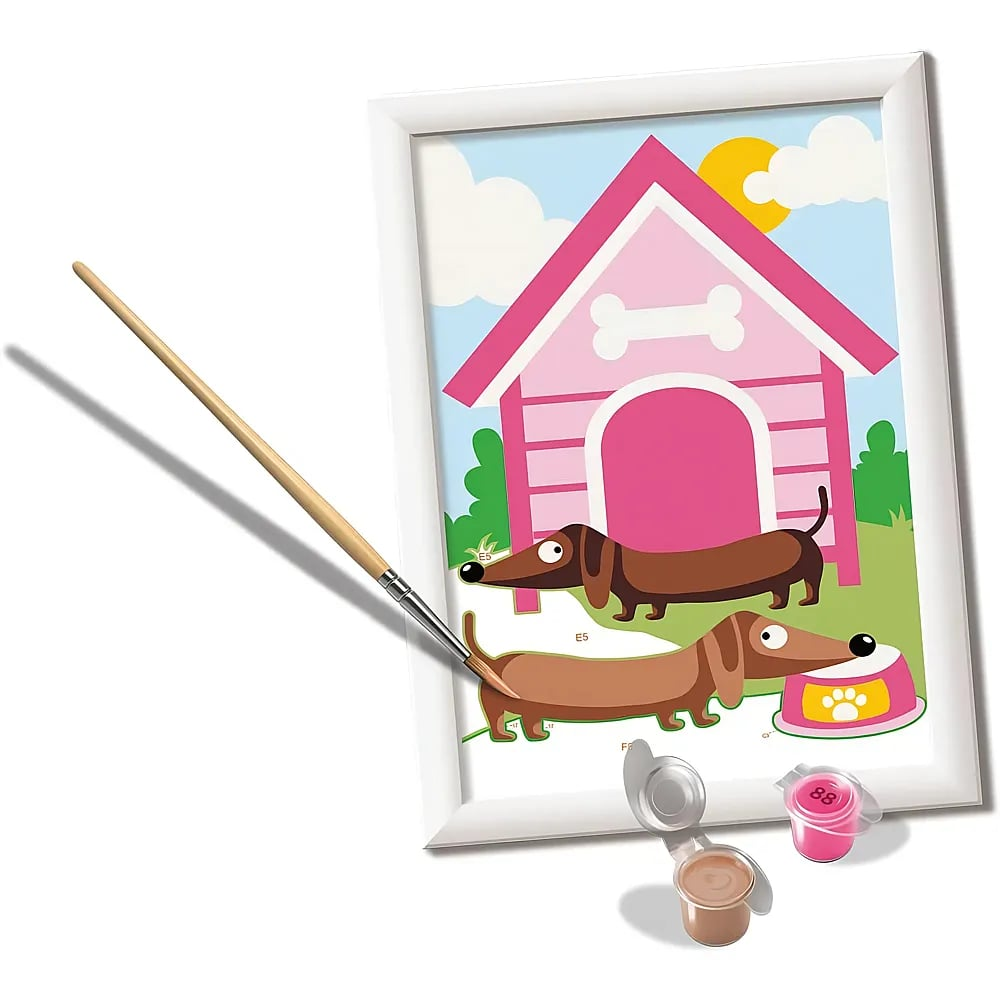 Un lienzo para pintar por números muestra una caseta rosa y salchichas, con pincel y tarros de pintura abajo.