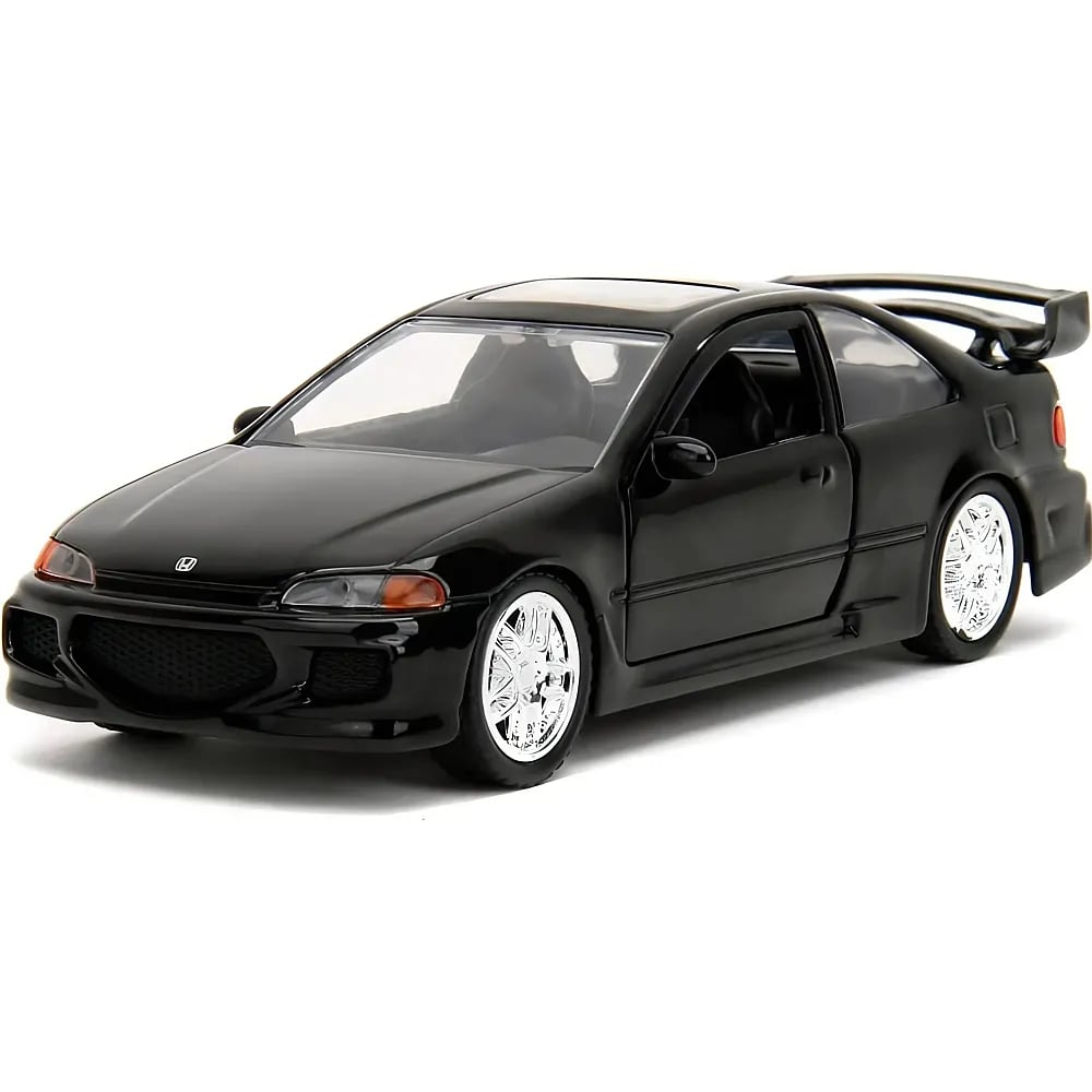 Une voiture miniature noire brillante avec des jantes argentées et un aileron arrière sur fond blanc.