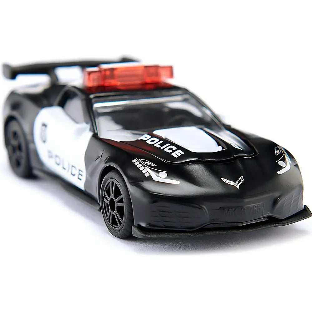 Une voiture de police jouet noire et blanche avec une sirène rouge sur le toit sur fond blanc.