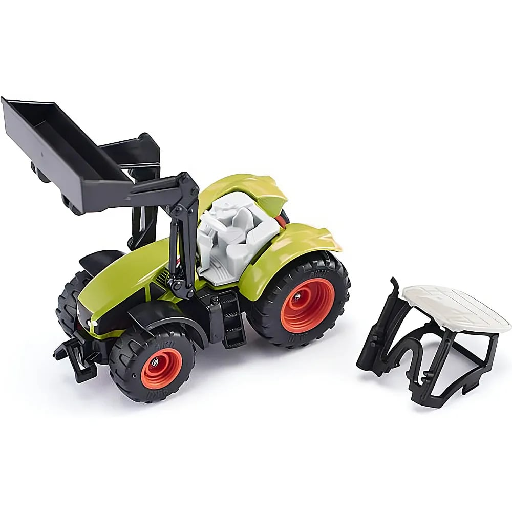 Ein grüner Spielzeugtraktor mit schwarzem Frontlader und rotem Felgen, daneben liegt eine abgenommene Fahrerkabine.