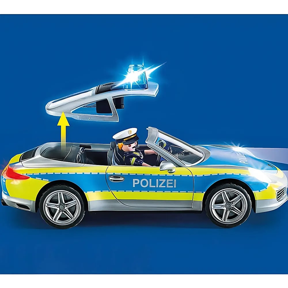 Un'auto della polizia Playmobil blu e gialla con tetto rimovibile e un agente alla guida su sfondo blu.