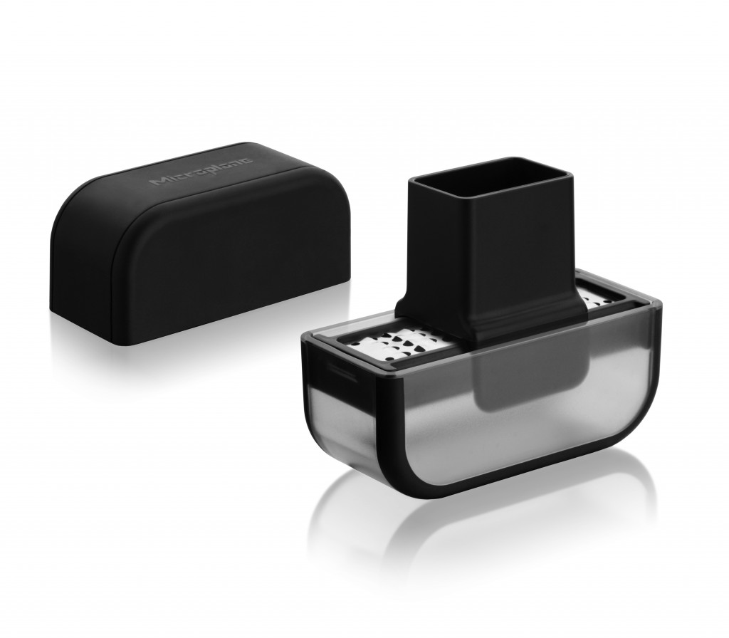 Schwarze Gewürzmühle mit transparentem Behälter und separatem Deckel auf weißem Hintergrund.