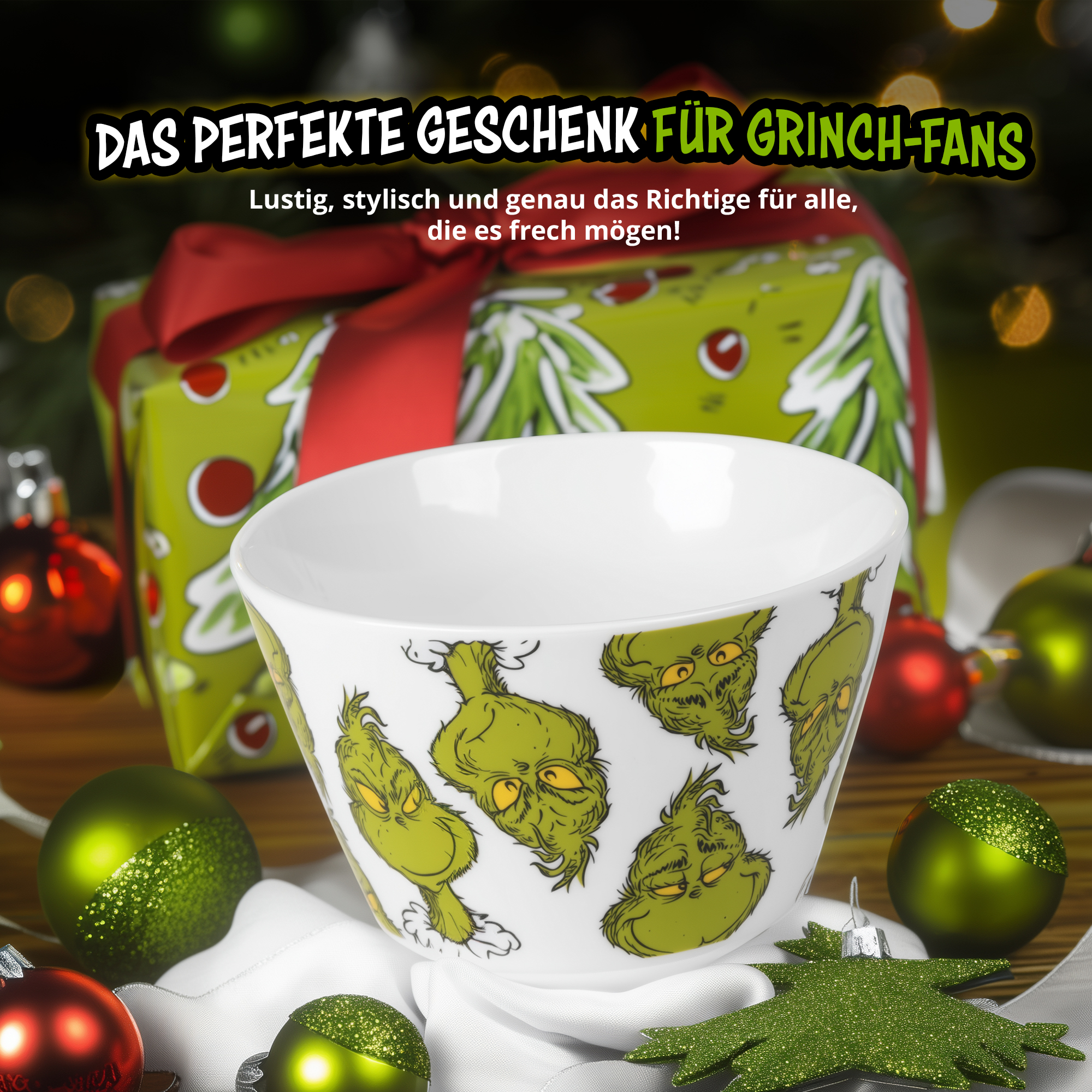 Eine weiße Schüssel mit Grinch-Gesichtern liegt zwischen Weihnachtskugeln, mit Geschenk und Text im Hintergrund.
