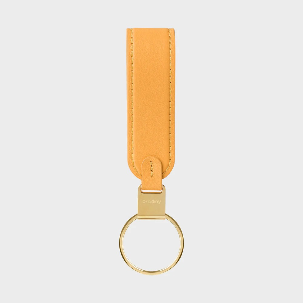 Pomarańczowy skórzany brelok do kluczy ze złotymi okuciami i zapięciem Orbitkey.
