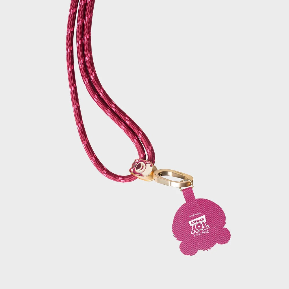 Różowa smycz Toy Story z plecionym sznurkiem, złotym zapięciem i głową Lotso na jasnoszarym tle.