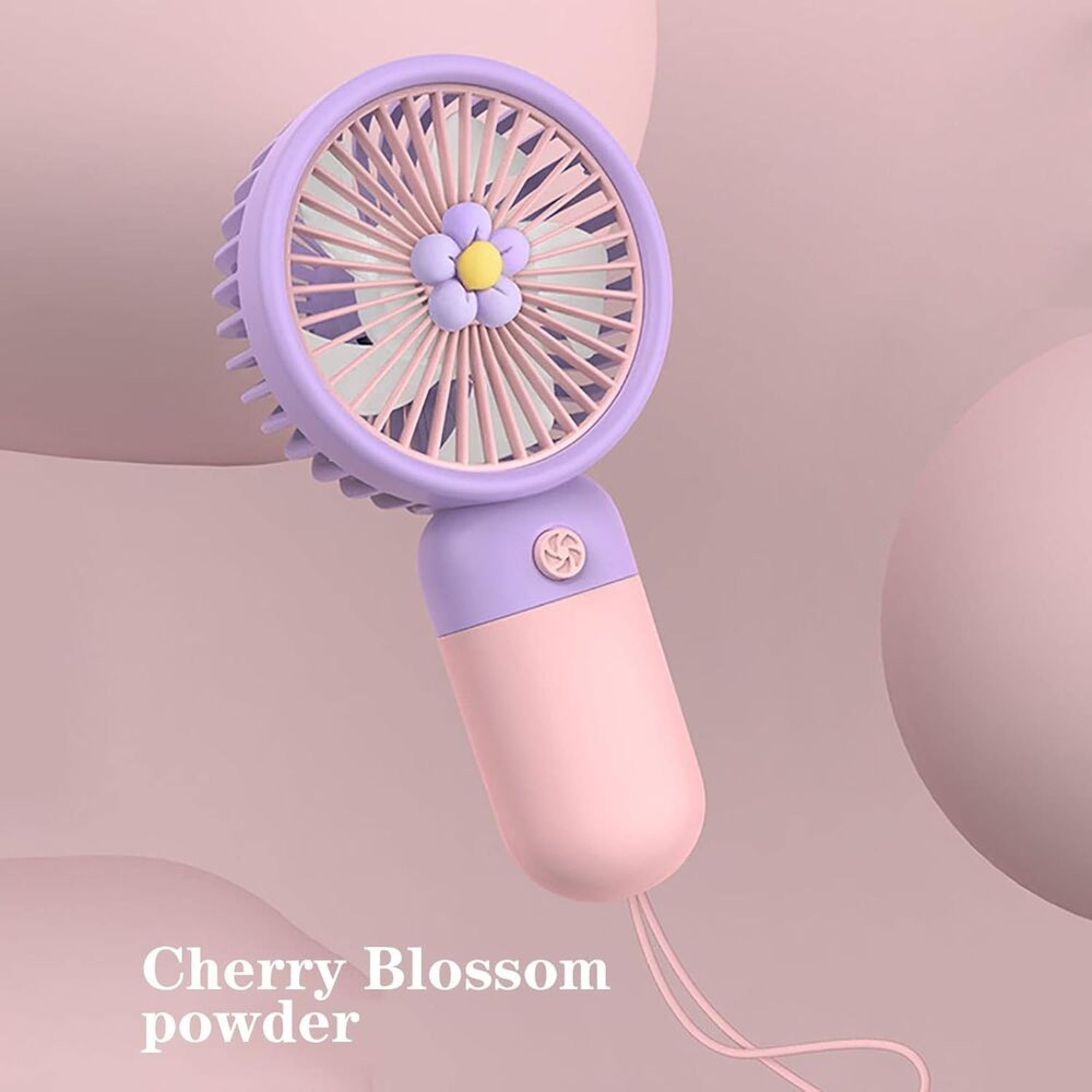 Tragbarer Handventilator in Lila und Rosa mit lilafarbenem Blumenmuster vor einem rosa Hintergrund.