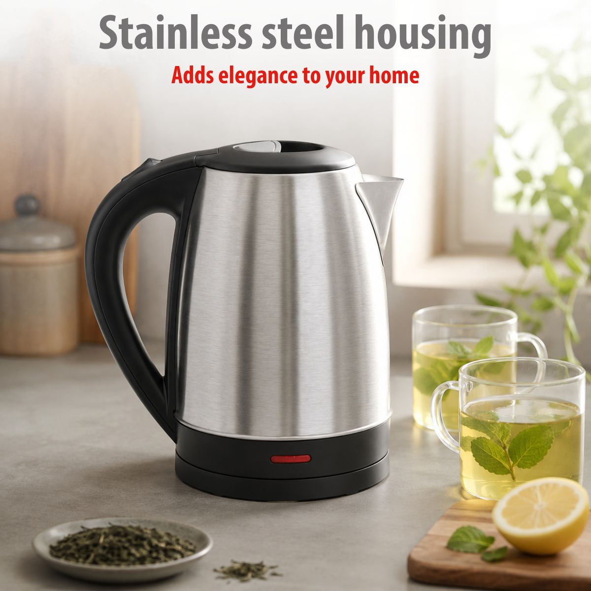 Stainless steel kettle with a black handle on a kitchen counter, flanked by tea glasses and a halved lemon.