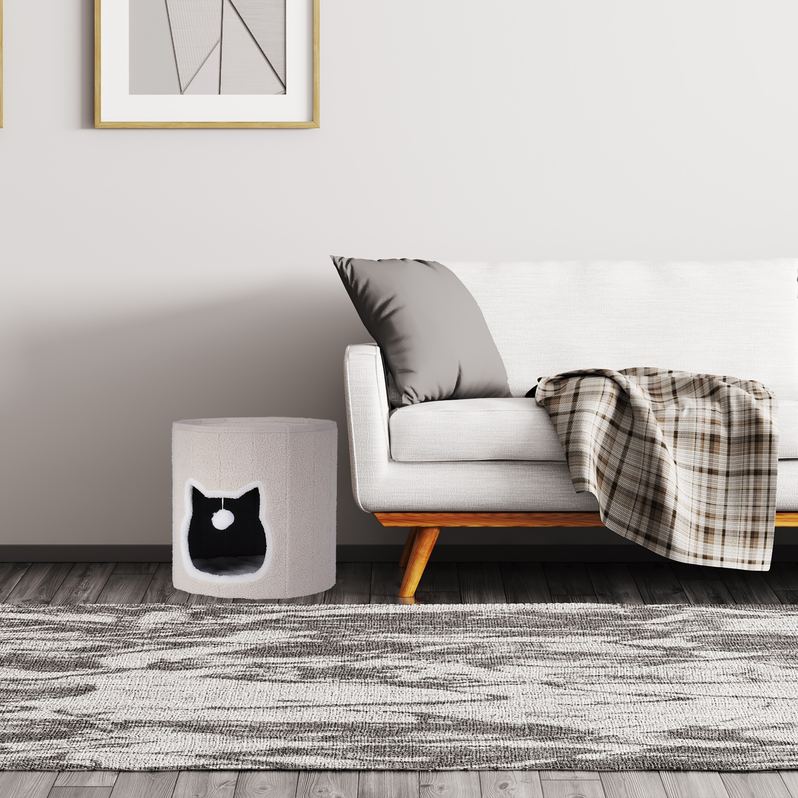Ein modernes Wohnzimmer mit weißem Sofa, grauem Kissen, karierter Decke und Katzenhaus.