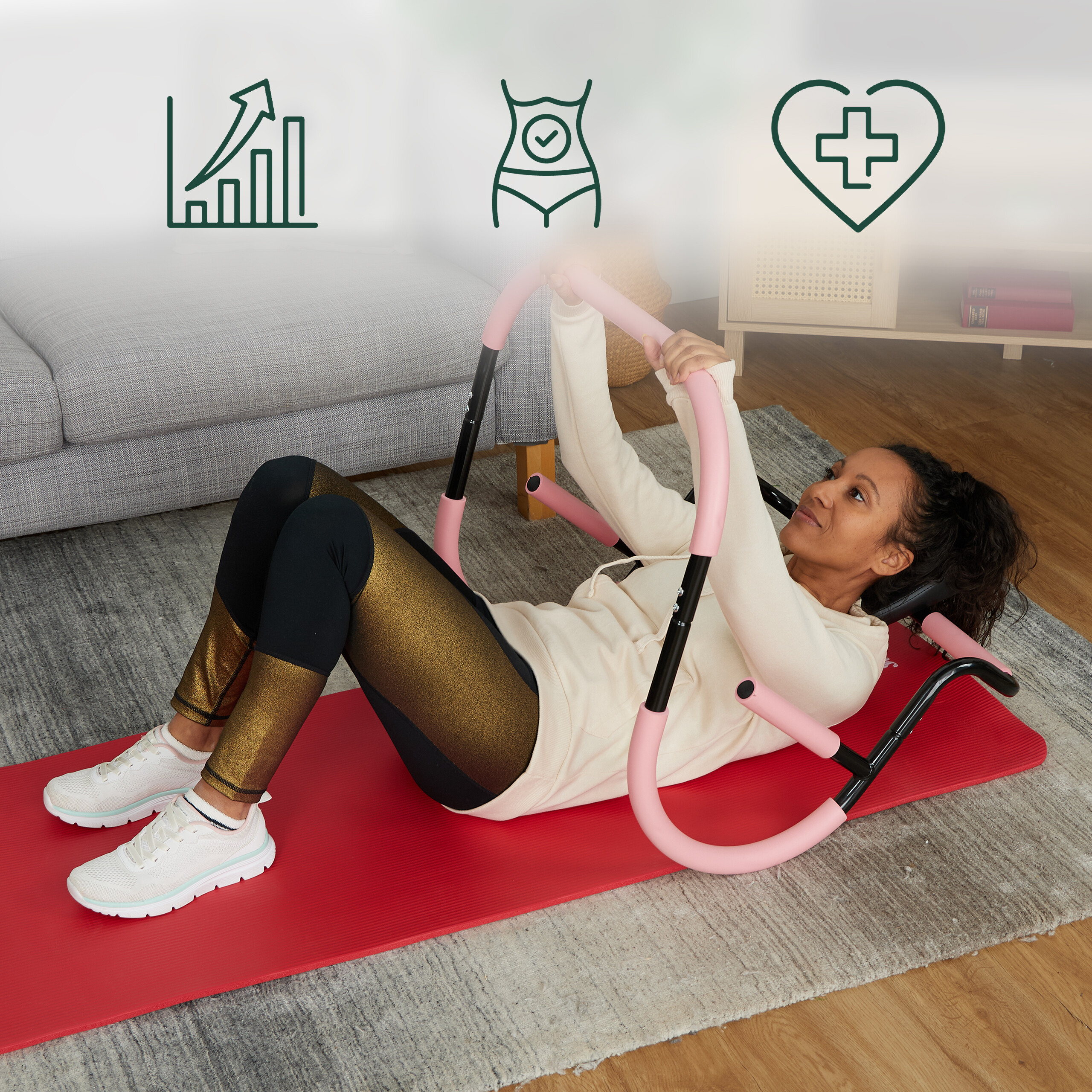 Eine Frau in Sportkleidung macht Crunches auf einer roten Matte mit einem pinken Trainingsgerät.