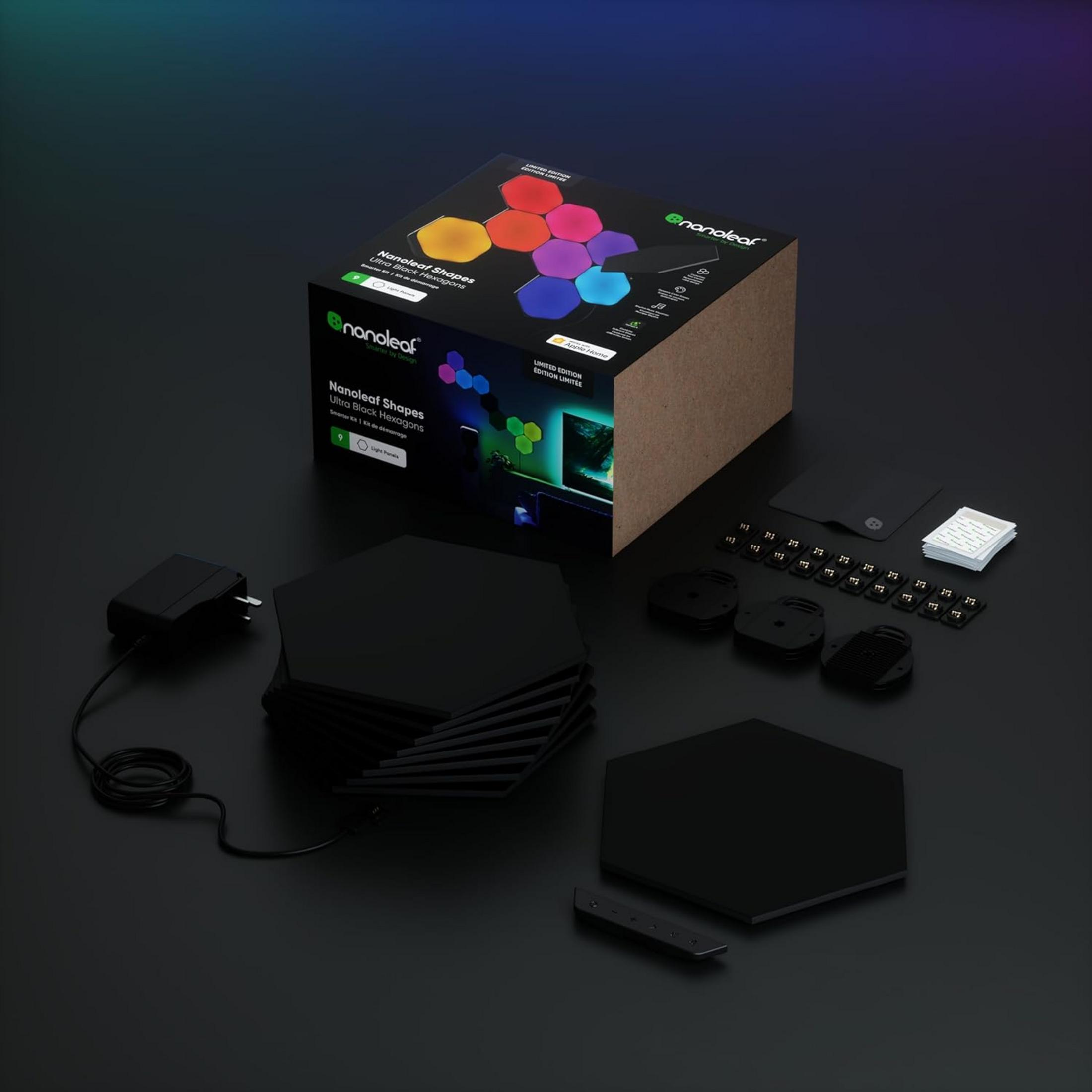 Zestaw sześciokątów Nanoleaf Ultra Black z pudełkiem, czarnymi panelami, zasilaczem, łącznikami i taśmą montażową.