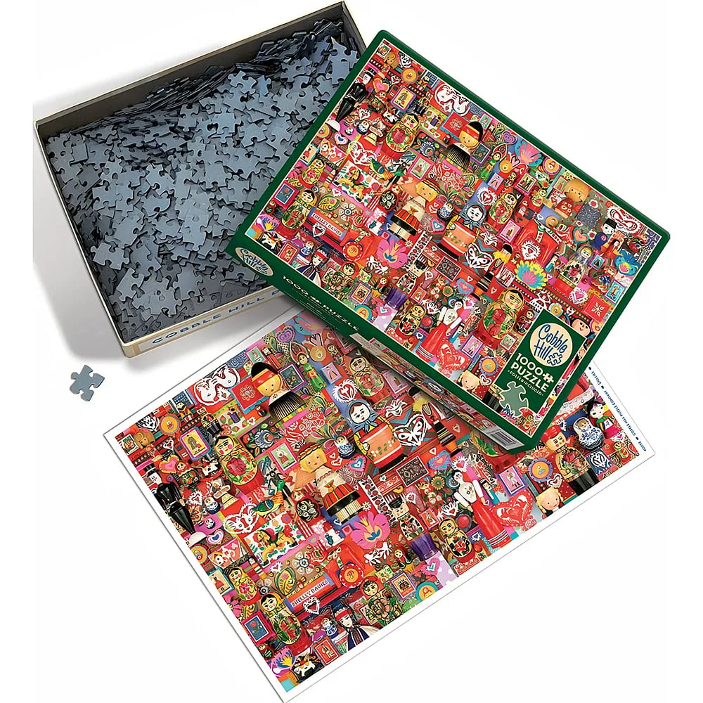 Ein 1000-Teile-Puzzle von Cobble Hill mit Schachtel, losen Puzzleteilen und Poster.