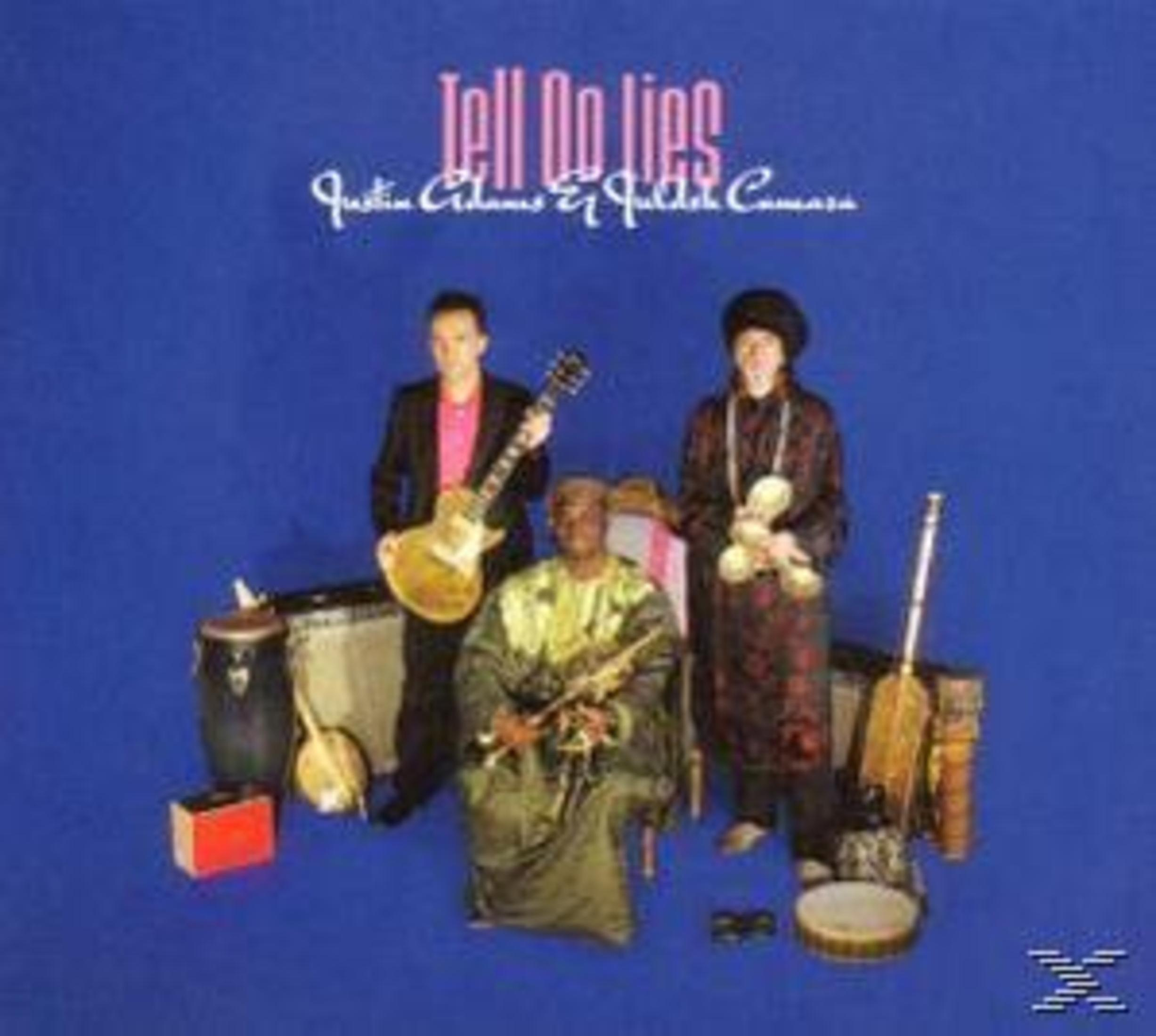 Drei Musiker mit Instrumenten vor blauem Hintergrund und dem Text 'Tell No Lies' oben.