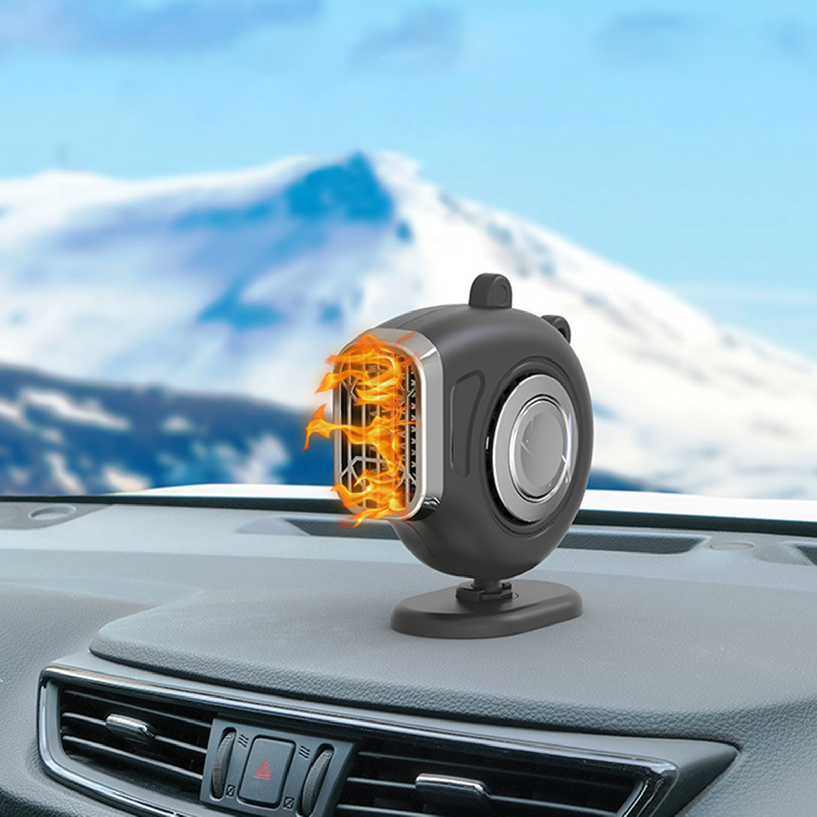 Ein schwarzer Autostart-Heizer mit Flammenmuster auf dem Armaturenbrett vor einer verschneiten Bergkulisse.