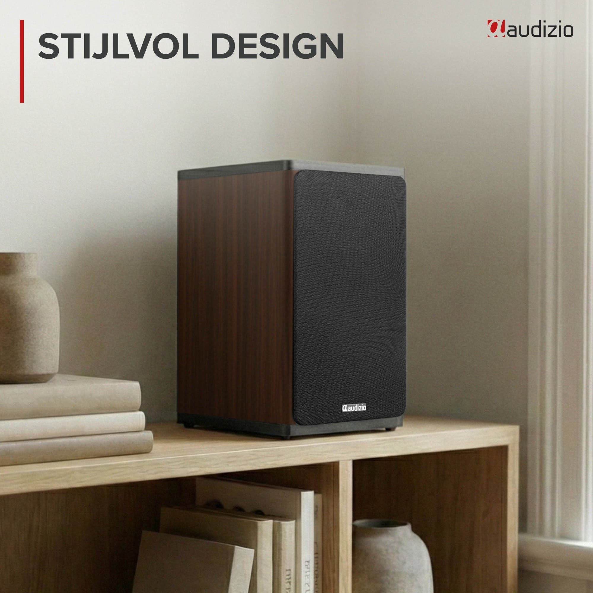 Un altavoz con acabado de madera y rejilla negra descansa en una estantería junto a libros.