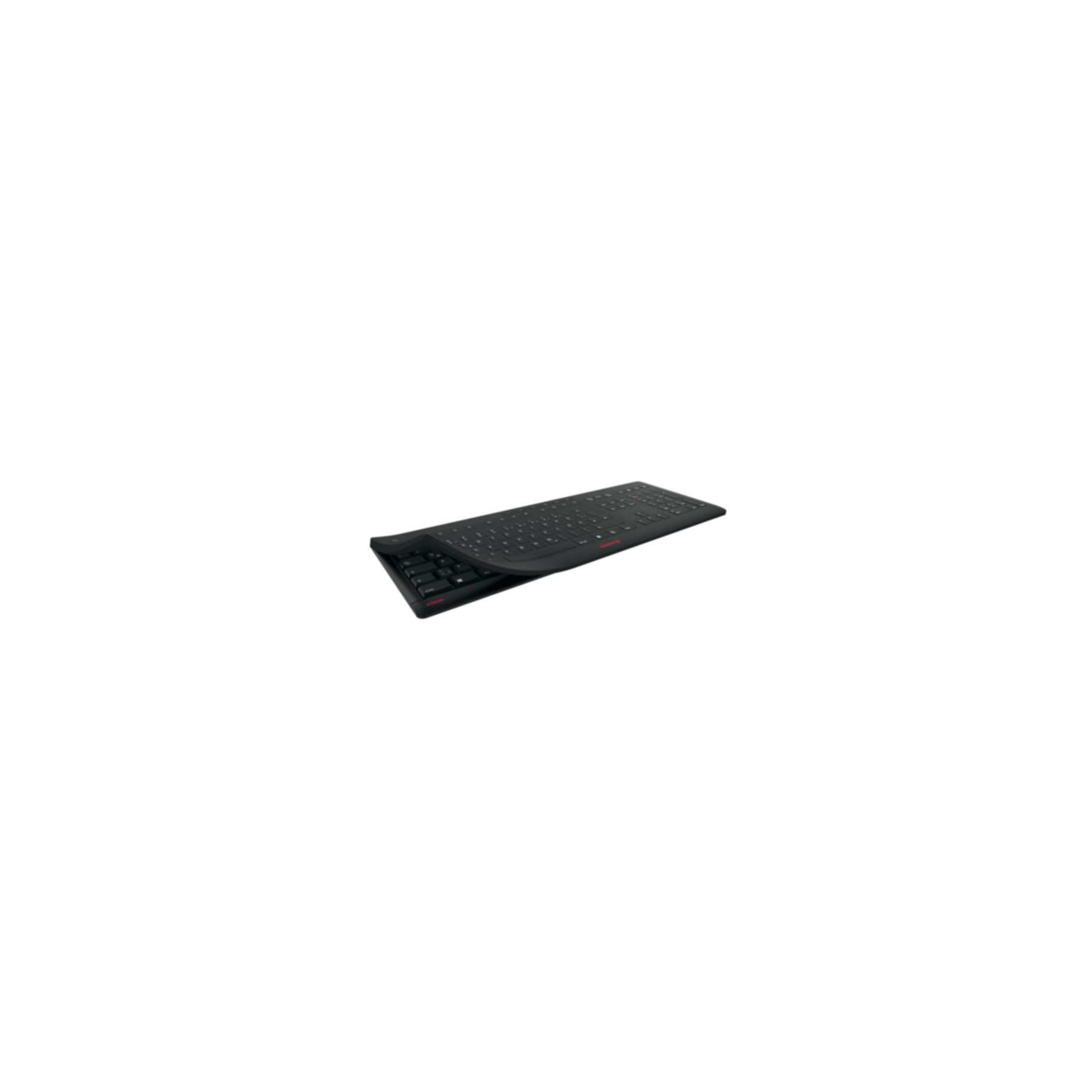 Un teclado negro descansa sobre una superficie blanca con una esquina ligeramente doblada hacia arriba.