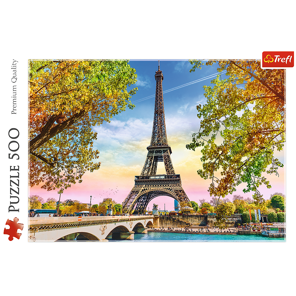 Eiffel Tower in Paris framed by trees, with a bridge and river in the foreground.