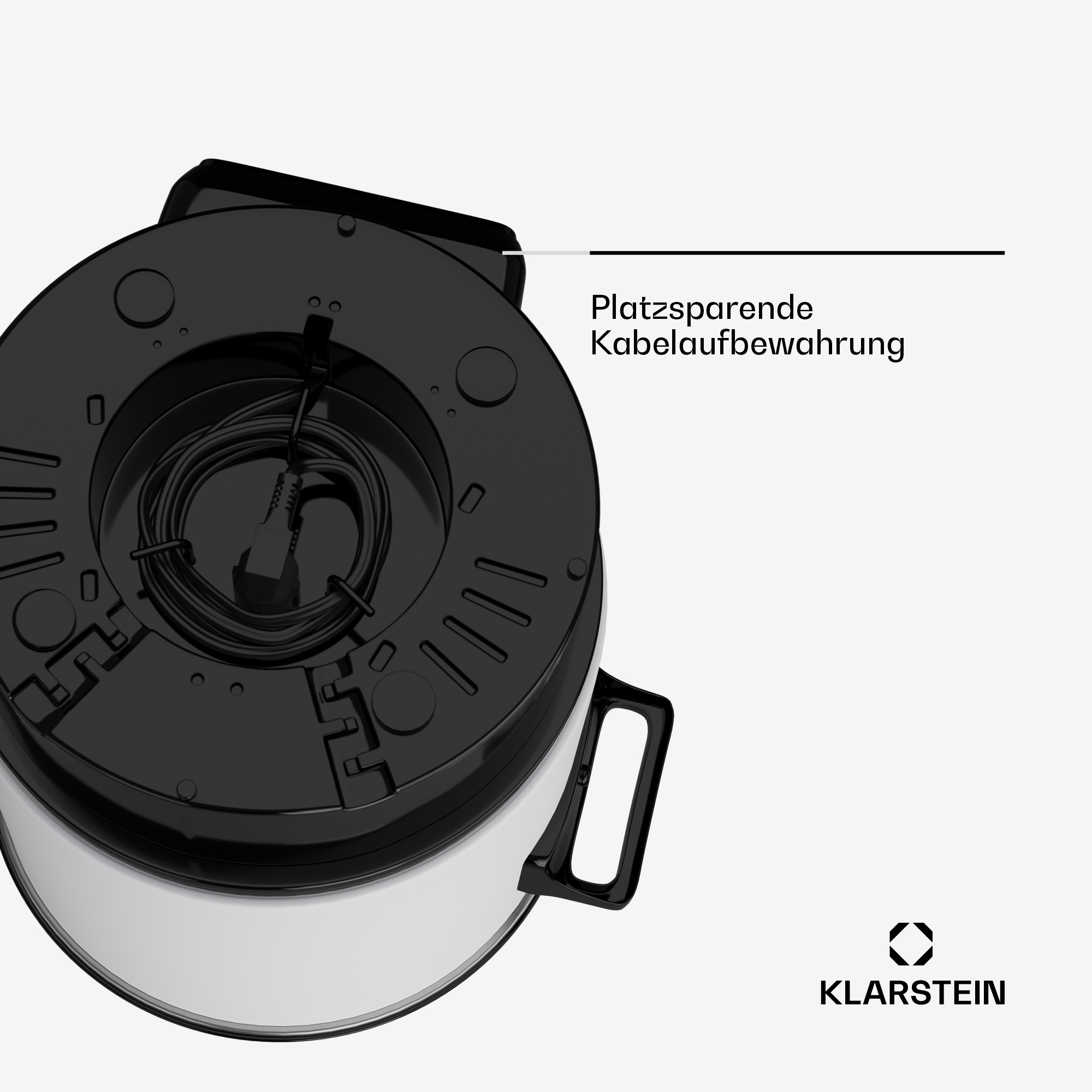 Unterseite eines silbernen Geräts mit schwarzem Boden und aufgewickeltem Netzkabel.