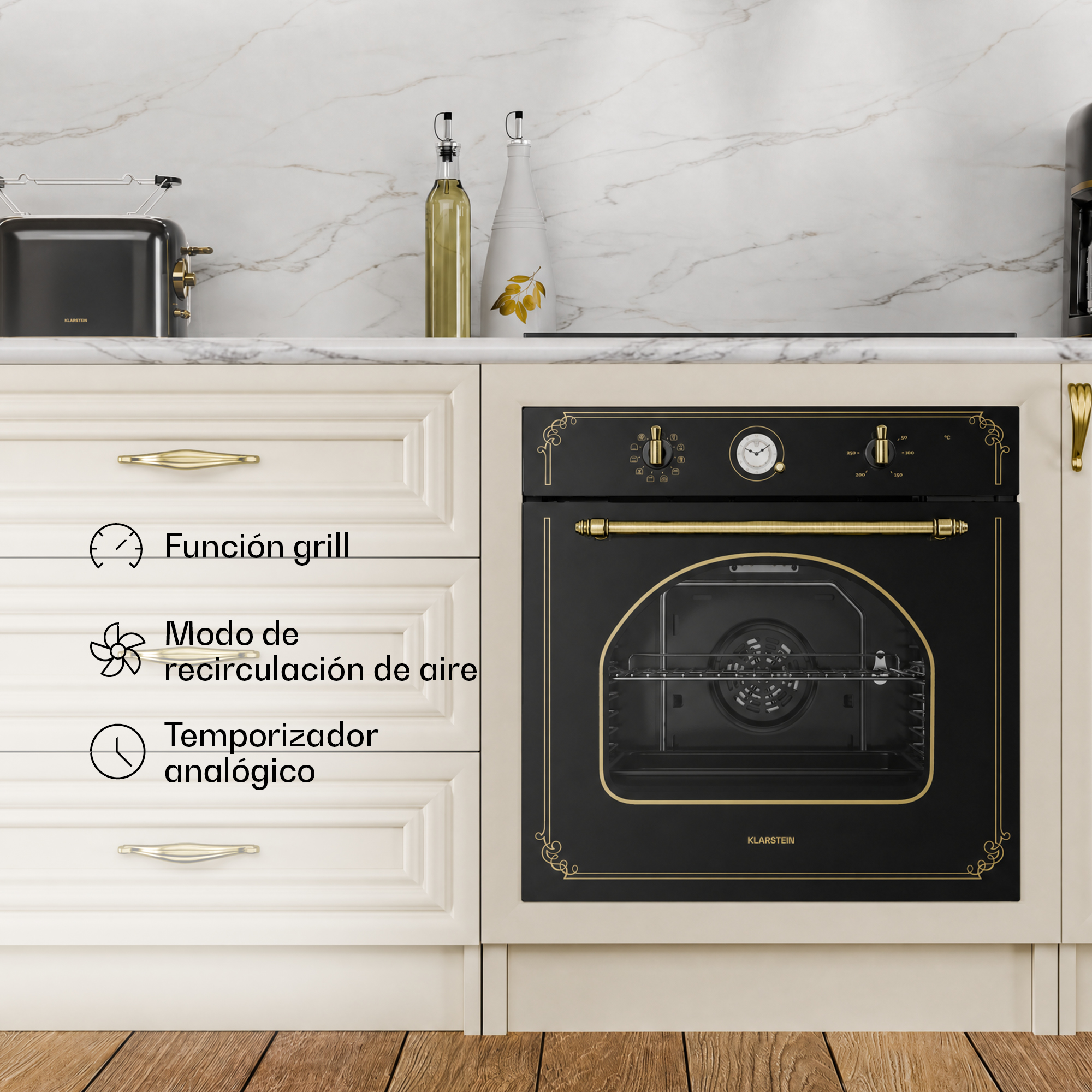 Un forno nero con dettagli dorati in una cucina luminosa con mobili bianchi e piano di lavoro in marmo.